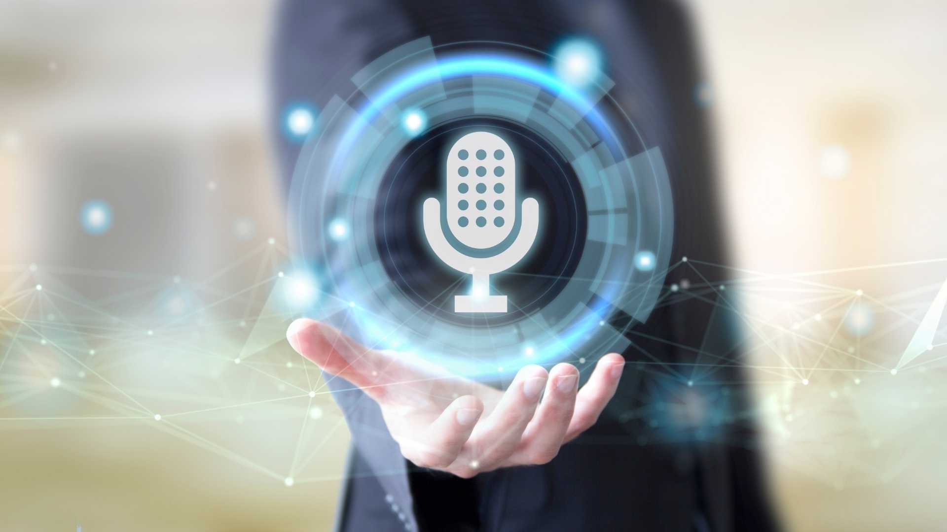 A digital microphone icon emerging from open hands, representing voice search optimization in SEO